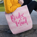 Preppy Pink Stripes Brush Script Bridesmaid Tote Bag<br><div class="desc">Personalised Bridesmaid tote bag featuring the word "Bridesmaid" in trendy brush script against a preppy pink stripes background that's perfect for your bridesmaid to carry her items. Check out the matching makeup bag here https://www.zazzle.com/preppy_pink_stripes_brush_script_bridesmaid_makeup_bag-223977580678893594?rf=238364477188679314 Personalise it by replacing the placeholder text. For more options such as to change the font...</div>