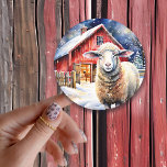 Pretty Watercolor Christmas Sheep and Rustic Barn Classic Round Sticker<br><div class="desc">A sweet watercolor sheep  standing in front of an rustic red barn on a snowy Christmas day.</div>