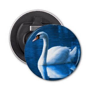 Pretty white swan floating on a blue lake bottle opener