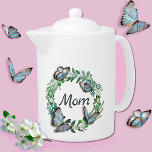 Pretty Wreath with Butterflies Mothers Day Teapot<br><div class="desc">Elegant white tea pot,  with graphics of a pretty plant leaf wreath,  with 3D looking butterflies and green text reading Mum.  Lovely gift idea for mum on Mother's Day.  Matching bone china cup available.</div>