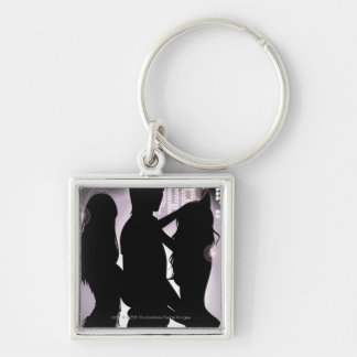 Profile of a man dancing with women in a nightclub key ring