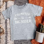 Promoted to Big Sister Pregnancy Announcement Baby T-Shirt<br><div class="desc">Custom printed apparel personalised with "Promoted to Big Sister" graphic in trendy modern fonts with a boho arrow design. Perfect for a pregnancy announcement photo or a gift for older siblings when new baby arrives! Use the design tools to edit the colours or add your own text and photos to...</div>
