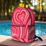 Psychedelic Hearts Calligraphy Script Name Pinks Printed Backpack<br><div class="desc">A funky heart pattern with pastel pinks and reds. The modern script adds a funky, modern touch to this retro design. Add your name or delete the text for a fun feminine backpack. The name is a trendy script in a large white size. If you click on the customise link,...</div>