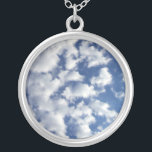 Puffy Clouds On Blue Sky Silver Plated Necklace<br><div class="desc">A bank of puffy white clouds breaks into small wispy pieces across the frame of the vertical photograph. The cloud cover is denser on the left and more sparse on the right, revealing a deep blue sky that is dark near the top of the photo and lighter near the bottom....</div>