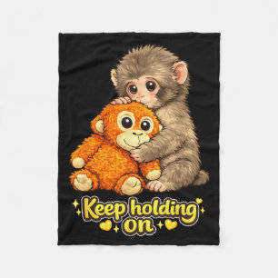 Punch monkey with teddy bear cuddling keep holding fleece blanket