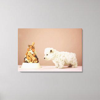 Puppy looking at pile of biscuits in dog bowl canvas print