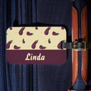 Purple eggplants on yellow luggage tag