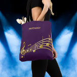 Purple gold music notes name tote bag<br><div class="desc">Simple and elegant for a music lover! A feminine and gilry dark purple background color with faux gold music notes. Template for your name,  golden hand lettered style script.</div>