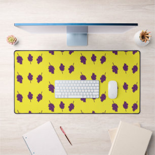 Purple grapes on yellow desk mat