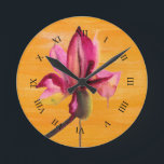 Purple Orchid watercolour orange pop art flower Round Clock<br><div class="desc">From original watercolour painting by Sacha Grossel of a purple watercolour flower design on a bright orange pop art vividly colored painted art background. This vibrant design was inspired by tropical floral climates and is a botanical meets pop art style.</div>