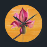 Purple Orchid watercolour orange pop art flower Round Clock<br><div class="desc">From original watercolour painting by Sacha Grossel of a purple watercolour flower design on a bright orange pop art vividly coloured painted art background. This vibrant design was inspired by tropical floral climates and is a botanical meets pop art style.</div>