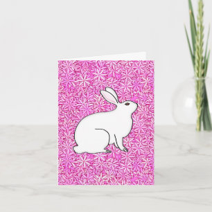 Rabbit on a bed of spring flowers holiday card