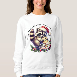 Racoon in a Santa hat enjoys cookies at Christmas Sweatshirt