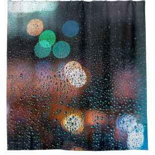 Raindrops on window, night city view through windo shower curtain