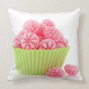 Raspberry tasty candy sweets in green cup cake cushion