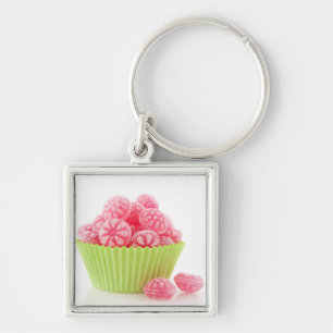 Raspberry tasty candy sweets in green cup cake key ring
