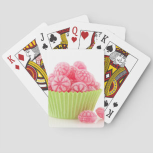 Raspberry tasty candy sweets in green cup cake playing cards