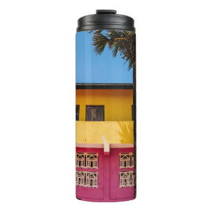 RED AND BROWN CONCRETE BUILDING NEAR TREE UNDER BL THERMAL TUMBLER