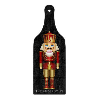 Red and Gold Nutcracker on Black Cutting Board