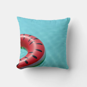 Red and green lifebuoy on swimming pool cushion