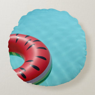 Red and green lifebuoy on swimming pool round cushion