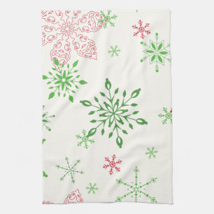 Red and Green Snowflakes on a white background Tea Towel