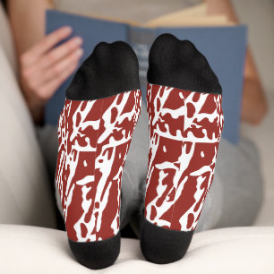Red and orange abstract shapes blend and overlap a socks