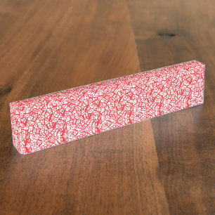 Red and orange wrapping paper with a geometric mot nameplate