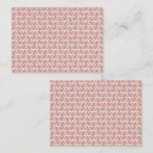Red and pink textiles laid over a patterned rug wi appointment card