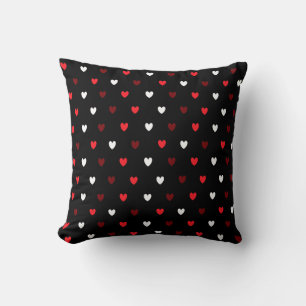 Red and white hearts on black cushion