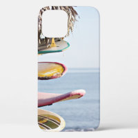 Red and white surfboard in brown wooden rack