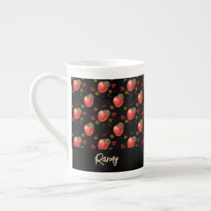 Red apples and leaves on black bone china mug
