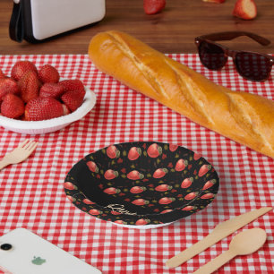 Red apples and leaves on black paper plate