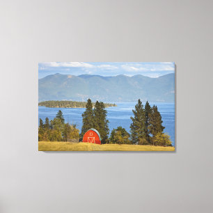 Red barn sits along scenic Flathead Lake near Canvas Print