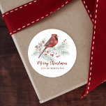 Red Cardinal Winter Pine Merry Christmas Classic Round Sticker<br><div class="desc">Add the finishing touch to your Christmas gifts and cards, with these delightful personalised stickers, featuring a cute watercolor red cardinal perched on a snow-covered pine branch, decorated with sprigs of holly berries. If you would like design tweaks or want the design on more products, please contact me through Zazzle...</div>
