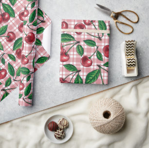 Red cherries on pink gingham wrapping paper