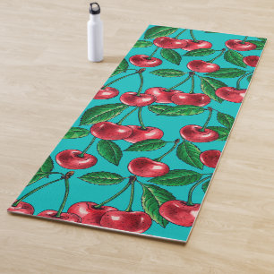 Red cherries on turquoise yoga mat