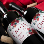 Red Christmas botanical floral cheers wedding Wine Label<br><div class="desc">Cheers calligraphy script and watercolor red burgundy and white peony flowers bouquets with pine green seasonal fir branches, red berries, and foliage together with bride and groom names over a clear white background making an inspired personalised wine label for your Christmas rustic elegant floral wedding or other winter seasonal celebrating...</div>