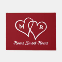 Red door mat with interlocking hearts and initials
