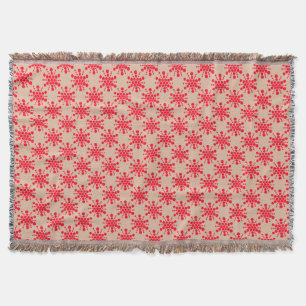 Red dotted star on taupe throw blanket