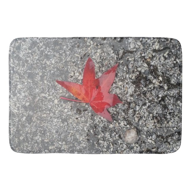 Red fall leaf in rain on grey textured road bath mat (Front)