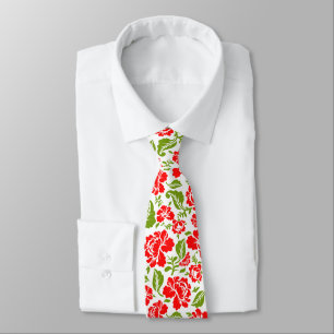 Red flowers with green leaves create a vibrant tie