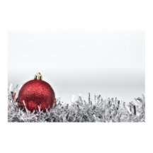 Red glittery Christmas ornament and silver tinsel