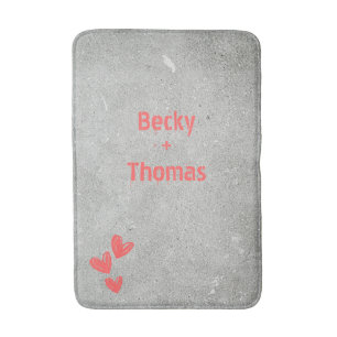 Red graffiti name on grey concrete, your  bath mat