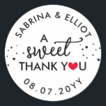 Red Heart A Sweet Thank You Wedding Favour Classic Round Sticker<br><div class="desc">A sweet thank you wedding favour sticker with a red heart replacing the O in you with your names in curved text along with your wedding date in black fonts against a white background.</div>
