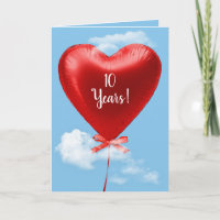 Red heart balloon in clouds for 10th anniversary