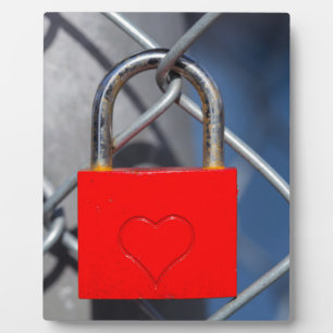 Red heart lock on fence plaque