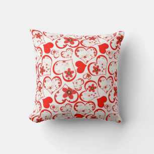 Red hearts and flowers on a white cushion