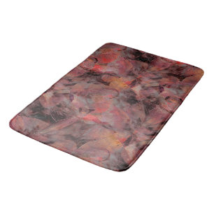 Red-hued patches on grainy black grey background t bath mat