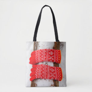 Red knitted gloves in snow tote bag
